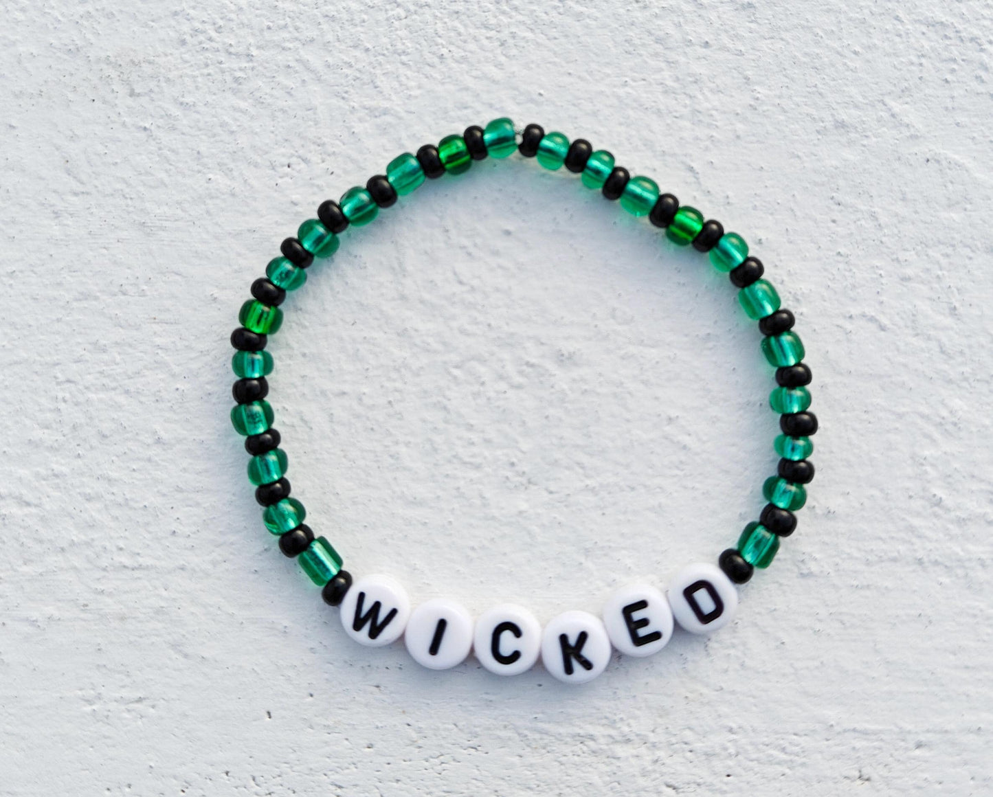 Wicked themed green and black seed bead bracelet on elastic string