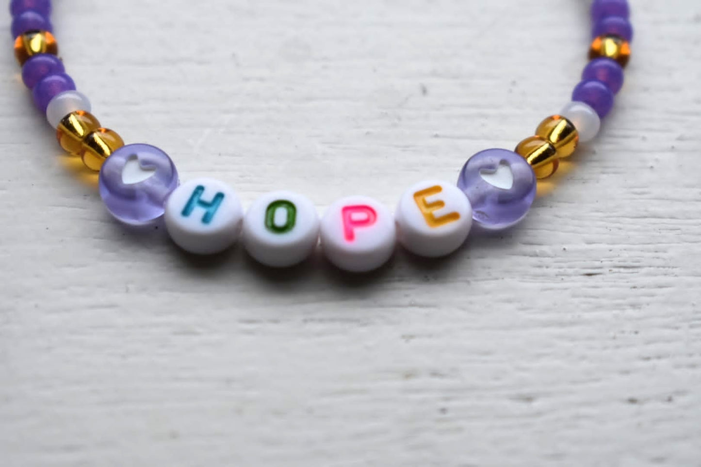 Purple and gold Hope bead bracelet