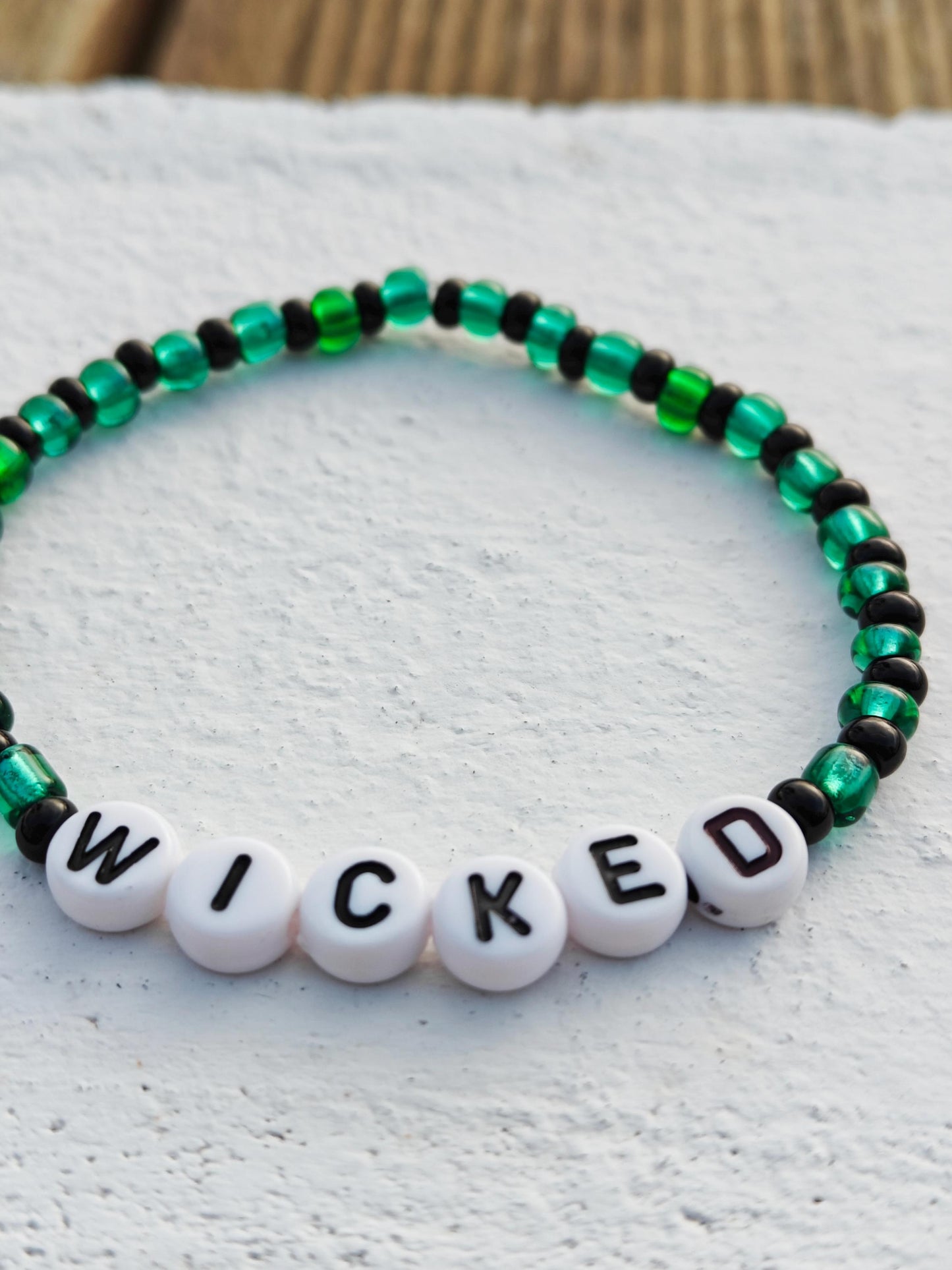 Wicked themed green and black seed bead bracelet on elastic string