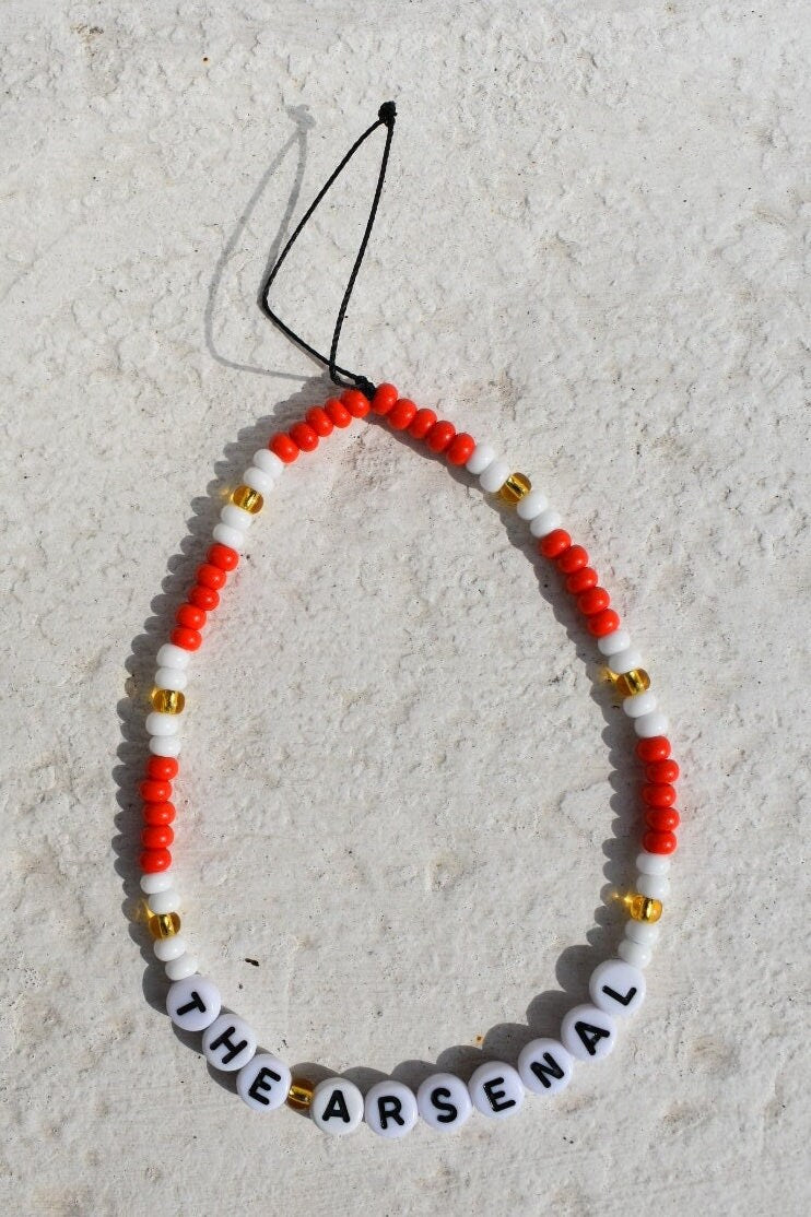 The Arsenal football club red, white and gold phone charm
