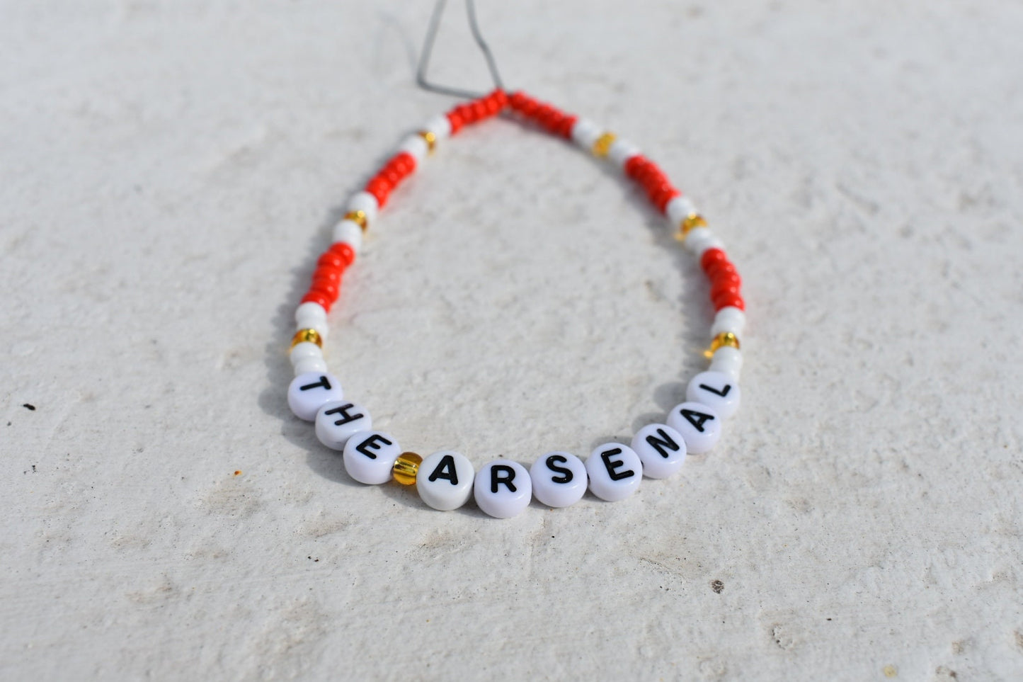 The Arsenal football club red, white and gold phone charm
