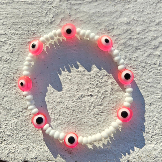 Evil eye inspired pink charm and seed bead bracelet