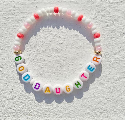 Colorful personalized name bead bracelet in pink white and gold with multicolored acrylic letter beads