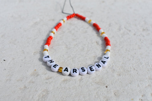 The Arsenal football club red, white and gold phone charm